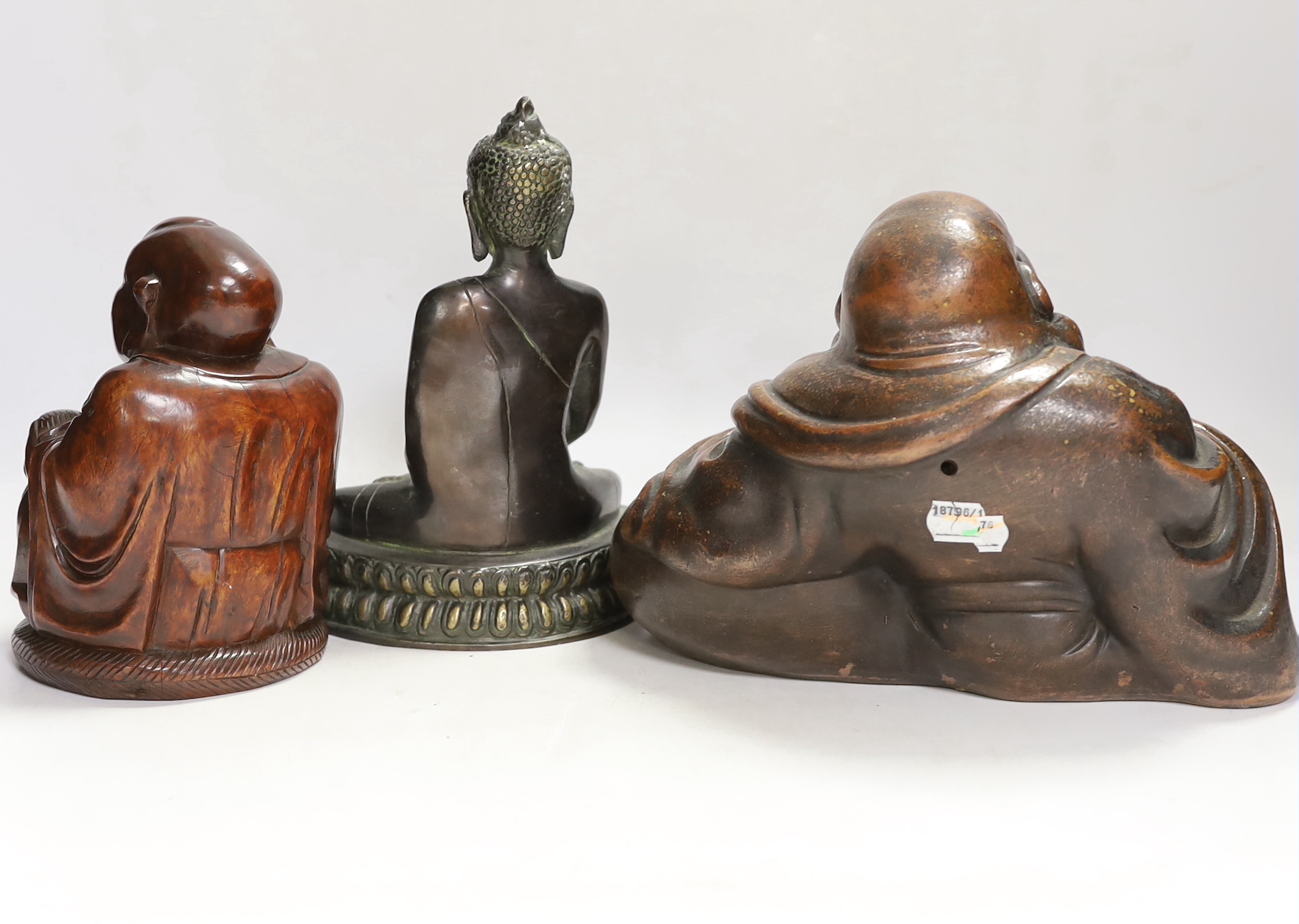 A bronze Thai Buddha, a composite Japanese Hotei and a carved wood example, tallest 20cm